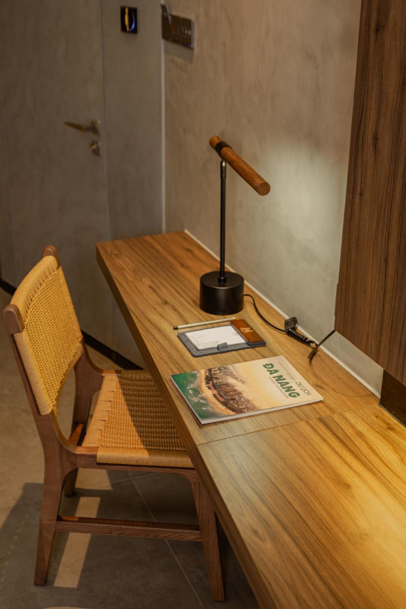 M Hotel Danang Exteriör bild A desk with a magazine on it